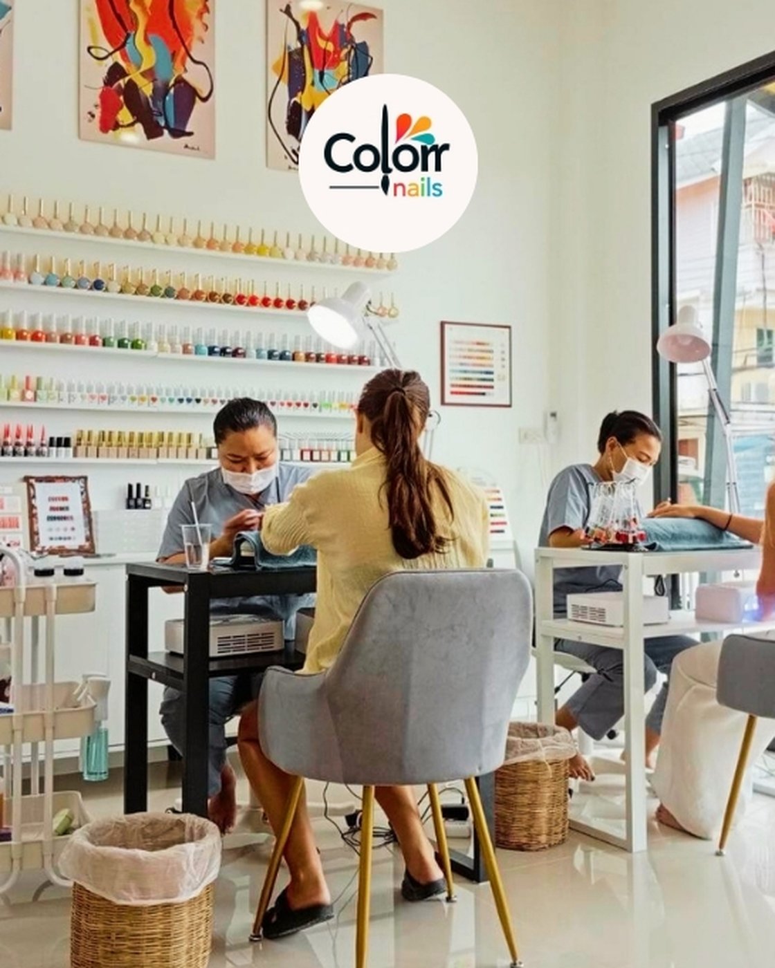 Two technicians giving manicures to guests at Colorr Nails studio, Koh Phangan