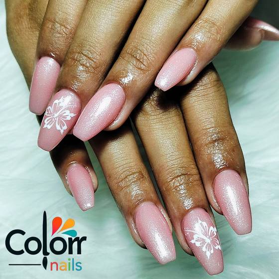 Soft pink nails with a hand-painted white butterfly