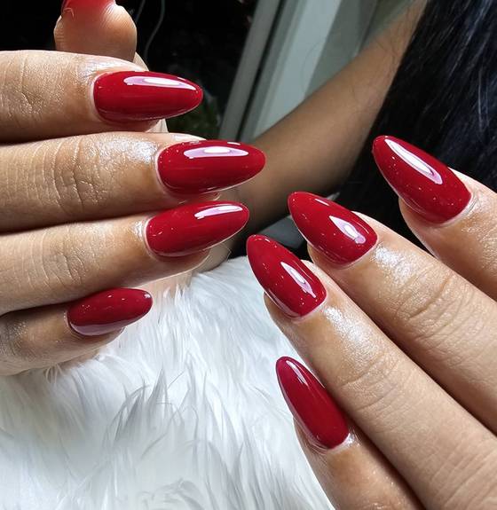 Glossy classic red almond-shaped nails