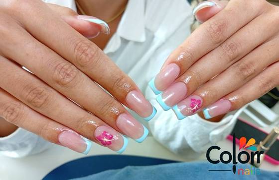 Blue French tip nails with a hand-painted pink hibiscus flower