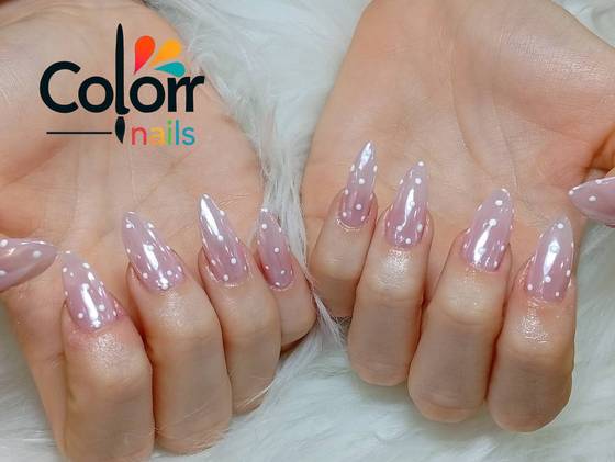 Nude nails with white polka dot detailing