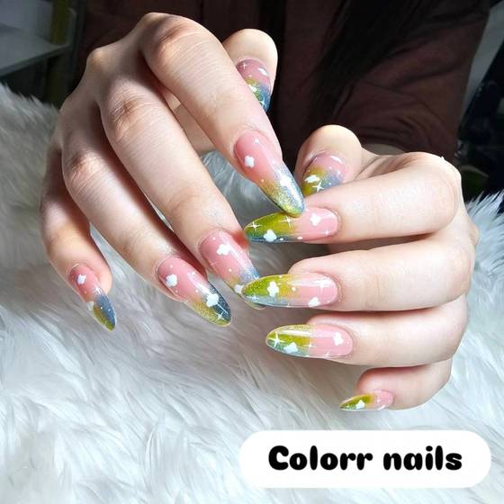 Sky-blue and green gradient nail art with clouds and stars